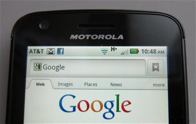 A Motorola phone displays the Google search page.