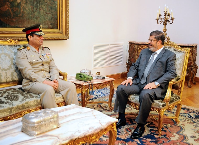 A handout picture released by the Egyptian presidency shows Egyptian President Mohammad Morsi, right, meeting Monday with newly-appointed Egyptian Defense Minister Abdel Fattah al-Sisi at the presidential palace in Cairo.