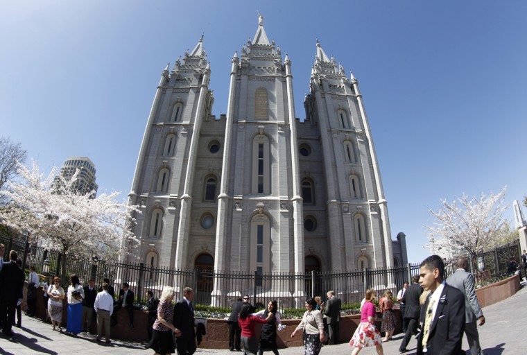 Mormons walk past the historic Mormon Salt Lake Temple as they attend the 182nd Annual General Conference of the Mormon Church on March 31 in Salt Lake City, Utah.