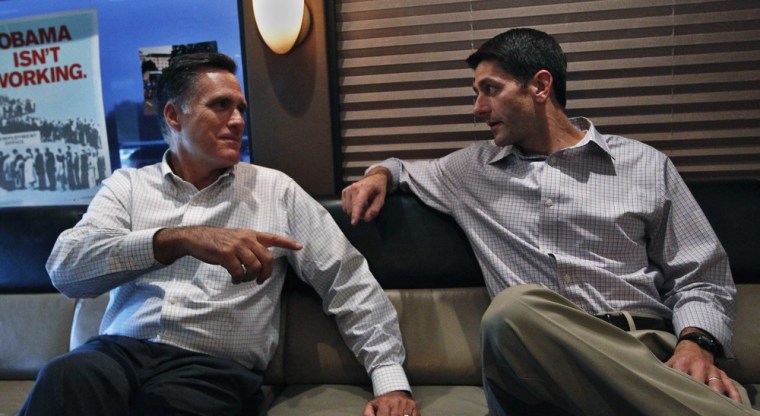 Republican presidential candidate Mitt Romney speaks with vice presidential running mate Congressman Paul Ryan on their campaign bus before a campaign event in Waukesha, Wisconsin August 12, 2012.