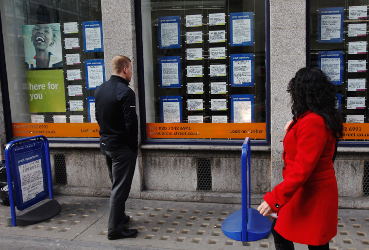 A man looks at advertisements posted in the window of a recruitment agency in London on March 14, 2012. Britain's economy has shrunk for the last nine months and now produces 4.5 percent less than before the economic crisis.