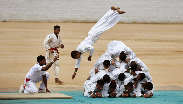 Indian army soldiers demonstrate a martial art technique on the occasion of 65th anniversary of India's independence from British rule, in Bangalore, India, on Aug. 15.