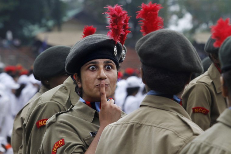 An Indian woman cadet from National Cadet Corps gestures towards her colleague on the occasion of 65th anniversary of India's independence from British rule, in Srinagar, India, on Aug. 15.