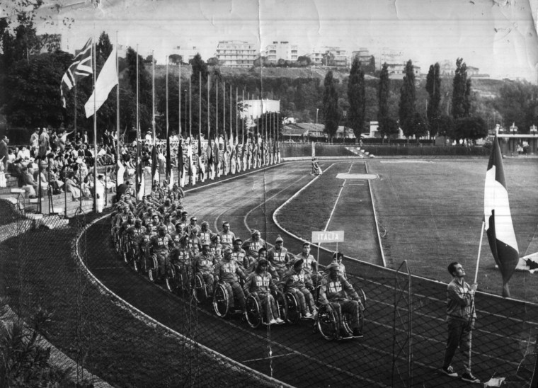 Competitors roll into the opening ceremonies of the first Paralympics, held in Rome in 1960.