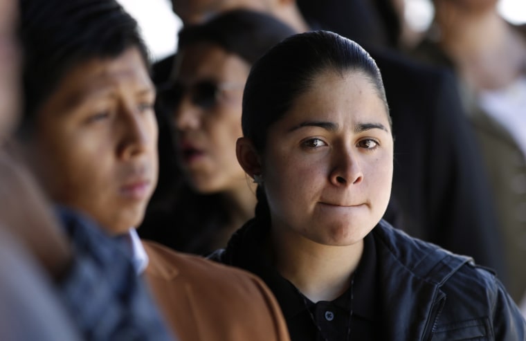 Job seekers wait in line to apply for the 300 available positions at a new Target retail store in San Francisco, Calif.