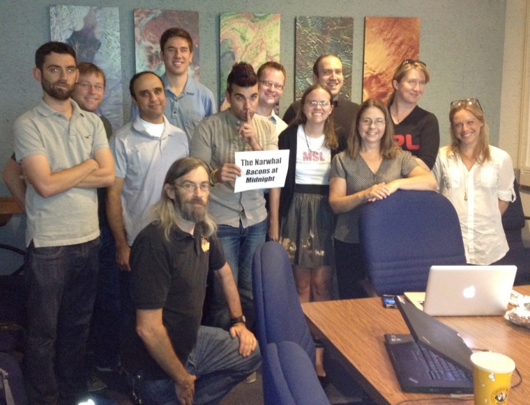 Members of the Curiosity rover's mission control team look into the camera for a group portrait at NASA's Jet Propulsion Laboratory in advance of a Reddit