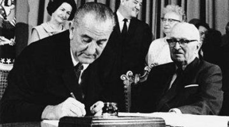 Democratic President Lyndon Johnson at a 1965 Medicare signing ceremony, along side Democratic President Harry Truman.