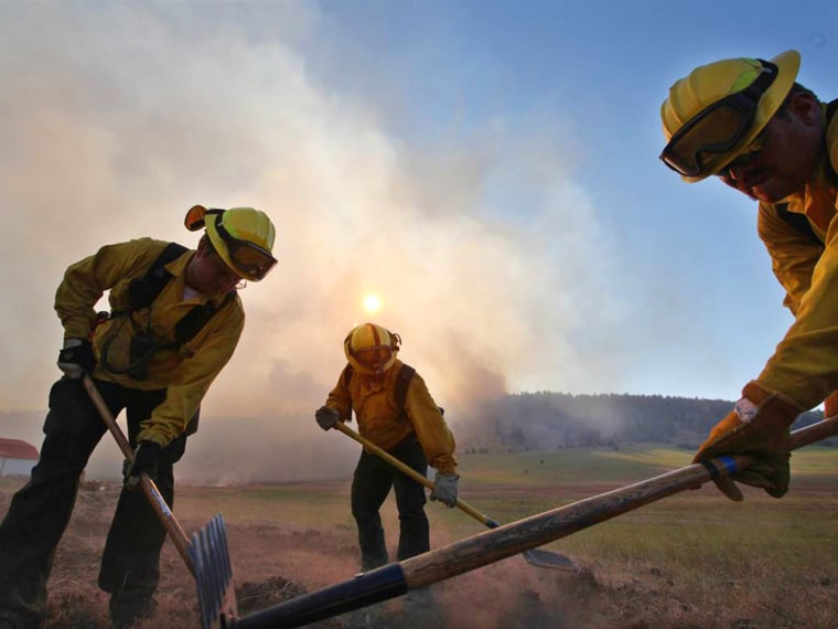 Blazes in multiple states threaten houses and cause evacuations.