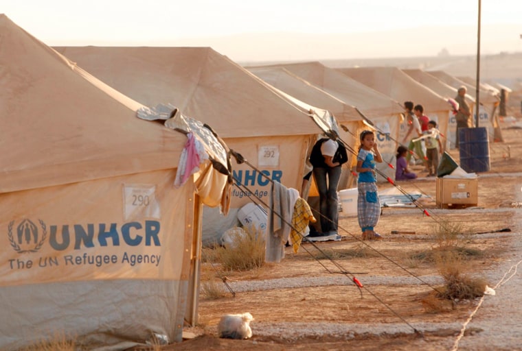 Refugees fleeing the violence in Syria gather at an emergency camp for Syrians in Zaatari village, east of Mafraq Governorate, Jordan, on July 31, 2012.
