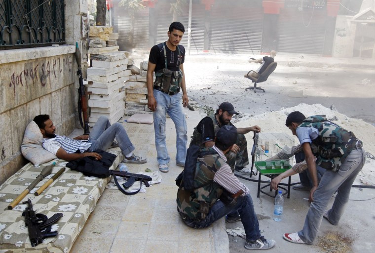 Free Syrian Army fighters take a break from the clashes in the Salaheddine neighborhood of central Aleppo on Aug. 17.