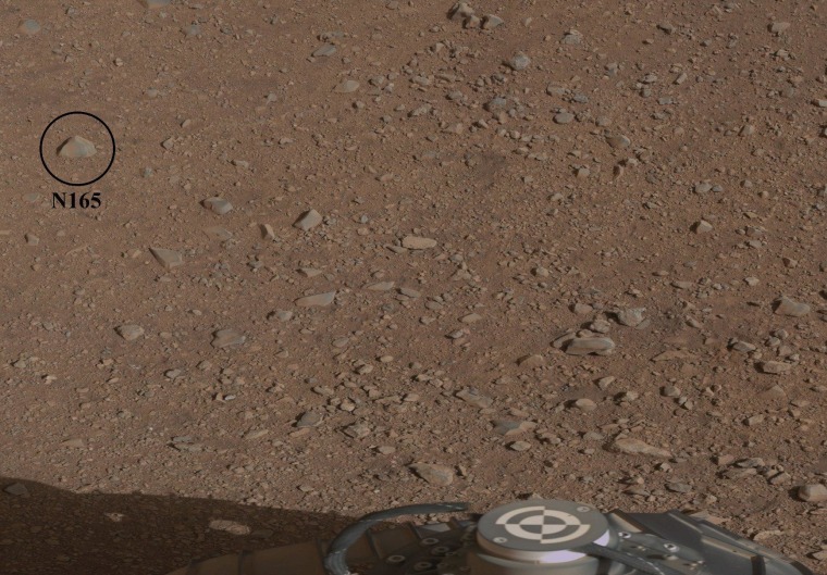 A photo from the Curiosity rover's Mastcam imaging system shows rover hardware in the foreground and highlights the location of a rock known as N165, which is the first target for the ChemCam laser zapper.