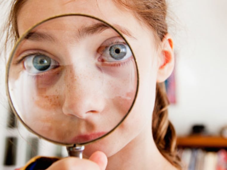 Looking through magnifying glass.