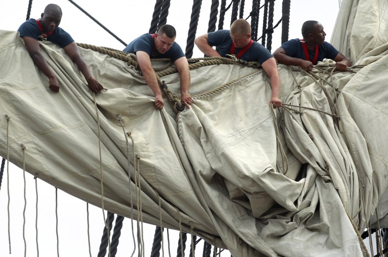 U.S. Navy personnel gather sails in the rigging of the USS Constitution as the vessel arrives at her berth in Charlestown Navy Yard, in Boston.