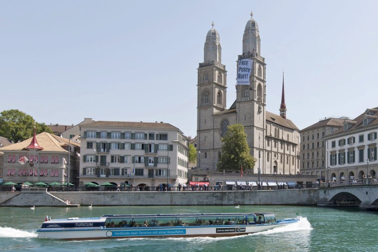 A boat passes in front of the Grossmuenster Cathedral in Zurich, Switzerland, on Aug. 20, where demonstrators hung a banner solidarity with the Russian punk band Pussy Riot.