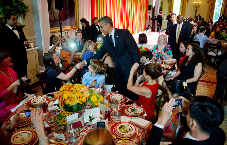 US President Barack Obama shakes hands with mothers and their children during first ever Kids'