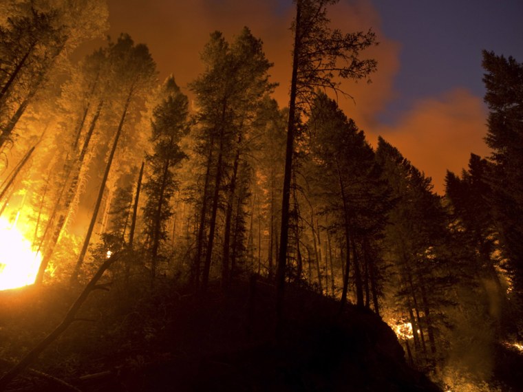 Blazes in multiple states threaten houses and cause evacuations.