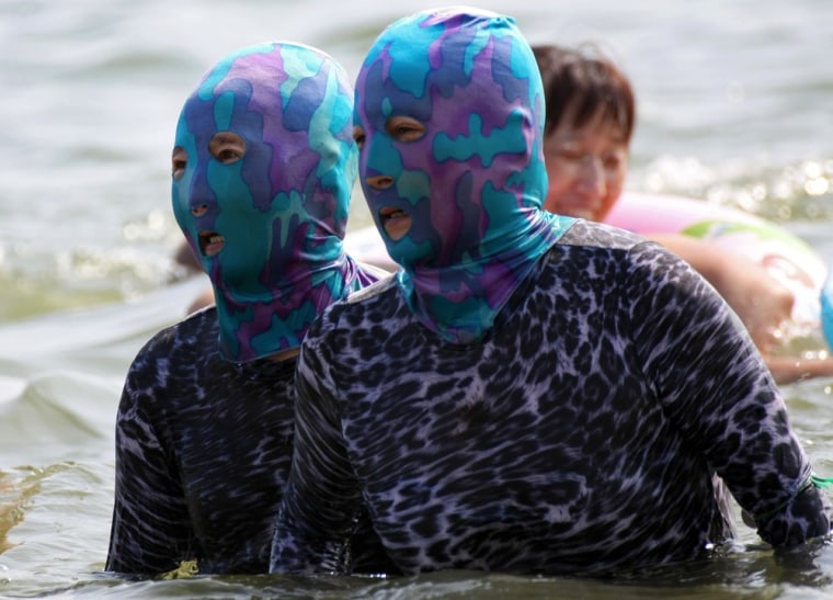 Facekini craze hits China beach as swimmers try to avoid a tan