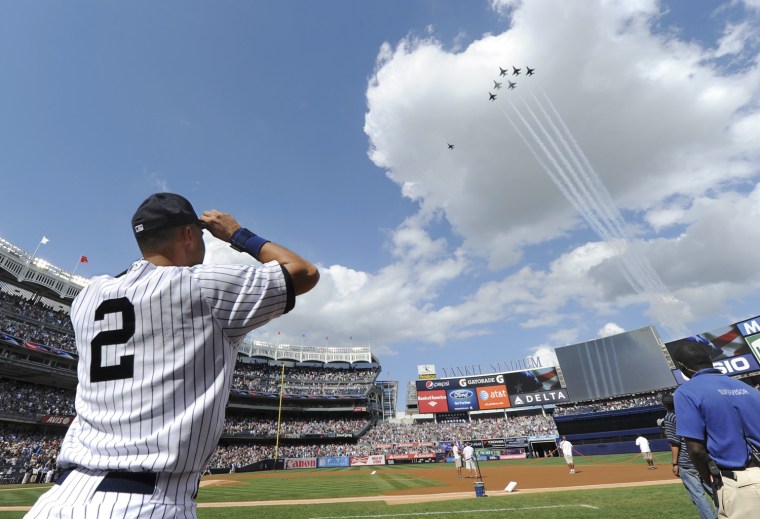 New York Yankees captain Derek Jeter, left, watches as the U.S. Air Force Thunderbirds fly in formation over Yankee Stadium on Saturday.