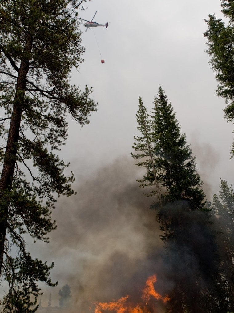 A helicopter flies over the Trinity Ridge Fire in Boise National Forest near Featherville, Idaho, in this U.S. Forest Service handout photo dated Aug. 19.