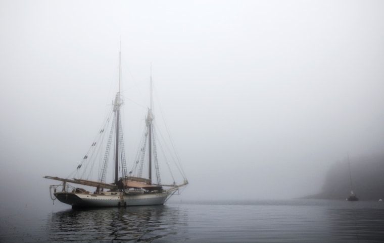 The schooner Mary Day sits at anchor in the morning fog off South Brooksville, Maine.