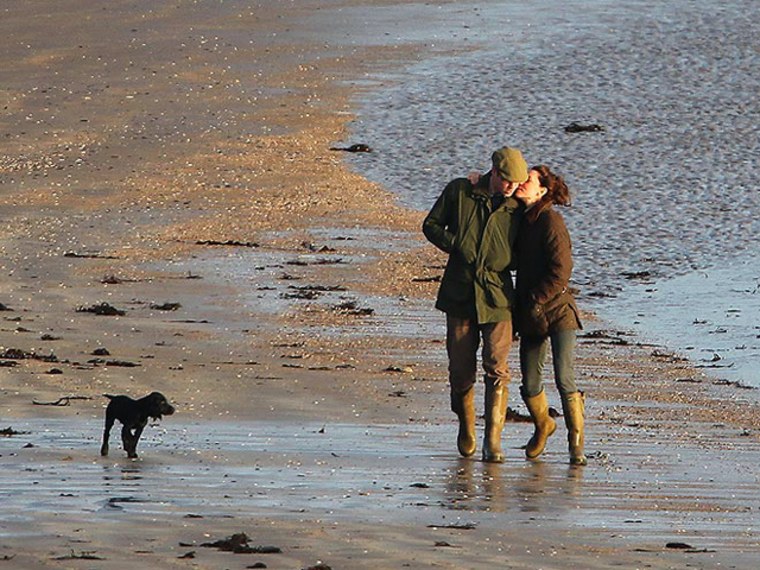It's a boy! Kate and Will walk with their new pup on Newborough Beach, January 12th.