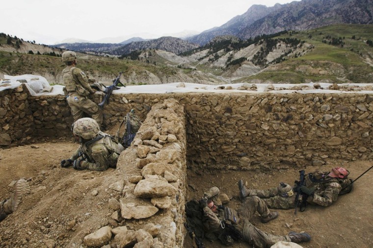 Paratroopers from Chosen Company of the 3rd Battalion (Airborne), 509th Infantry rest towards the end of a helicopter assault mission to improve their biological database, near the town of Ahmad Khel in Afghanistan's Paktiya Province on July 16.