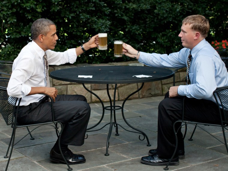 President Barack Obama offers a toast of his homebrewed beer to Dakota Meyer on the patio outside of the Oval Office on Sept. 14, 2011.
