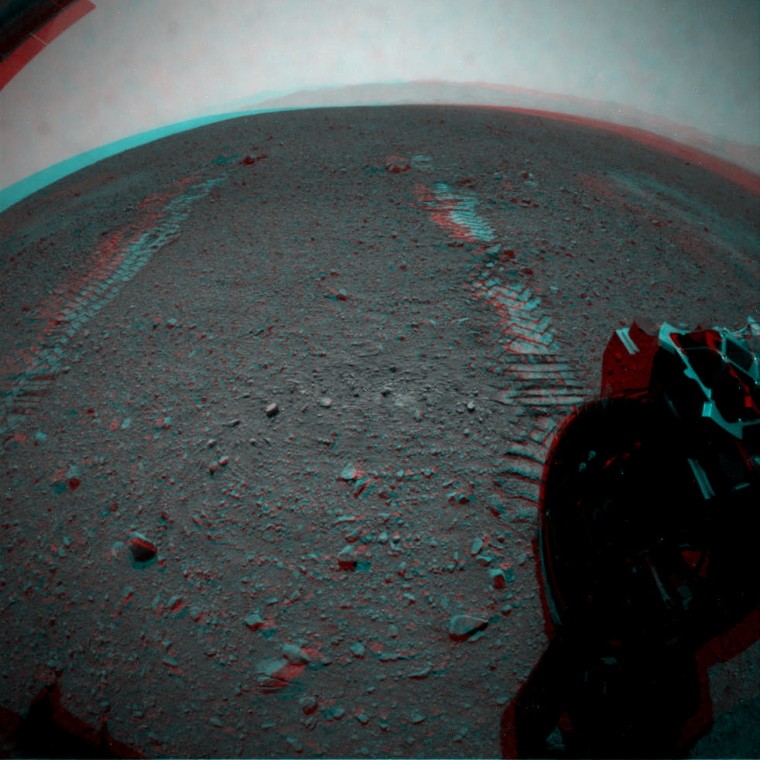 Image-processing whiz Stuart Atkinson produced this 3-D view of wheel tracks extending away from NASA's Curiosity rover on Mars, as captured by the rover's hazard avoidance cameras. On either side of the tracks, you can see bright spots, or