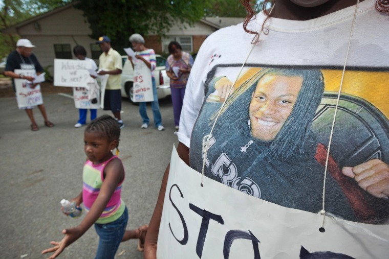 A young girl wears a shirt she made emblazoned with the image of the late Chavis Carter, a 21-year-old Jonesboro police say shot himself in the temple in the back of a police cruiser, despite his hands having been handcuffed behind his back.