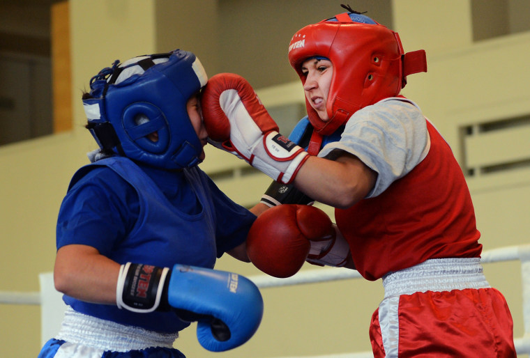 Russian junior female boxers clash during their bout at the All-Russian Women's Junior Boxing Tournament 'Olimpiyskiye Nadezhdy (Olympic Hopefuls)' at a countryside sport campus in Tula region, on Aug. 22.
