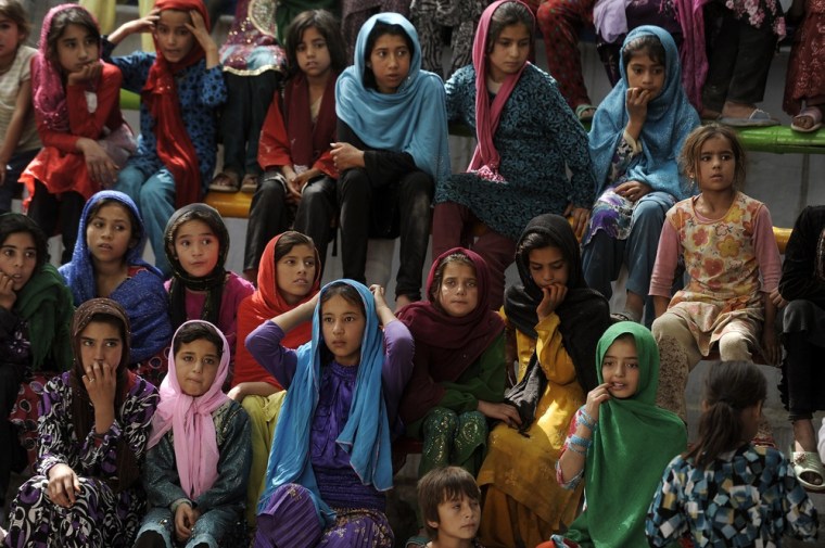 Young female Afghan audience members watch a performance during the 7th Afghanistan Juggling Championships in Kabul.