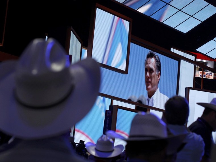 Delegates look at an image of U.S. Republican presidential candidate and former Massachusetts Mitt Romney displayed during the opening session of the Republican National Convention in Tampa, Florida, August 27, 2012.