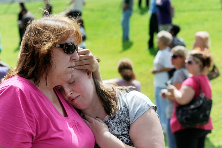 Tracie Bradford, of Perry Hall, Md., consoles her daughter Leah, a student at Perry Hall High School who says she was in the school's cafeteria when a student was shot there and critically wounded on the first day of classes, Monday, Aug. 27, 2012, in Perry Hall, Md. A suspect was taken into custody shortly after the shooting, according to police. No one else was reported injured. (AP Photo/Steve Ruark)