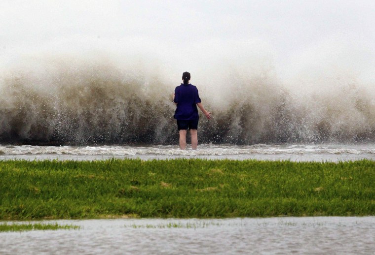 New Orleans resident Diana Whipple stands on the shore of Lake Pontchartrain as Tropical Storm Isaac approaches New Orleans, Louisiana, Aug. 28. Tropical Storm Isaac was near hurricane force as it bore down on the U.S. Gulf Coast on Tuesday and was expected to make landfall in the New Orleans area seven years after it was devastated by Hurricane Katrina.