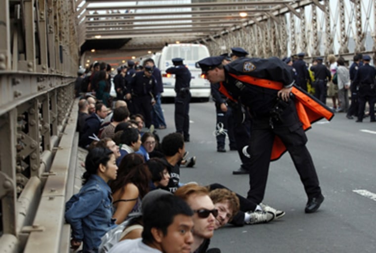 A police officer leans over to talk to a protester after hundreds were arrested during an Occupy Wall Street march on the Brooklyn Bridge in New York October 1, 2011.