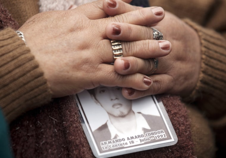 A woman holds a photo of her dead son during a memorial honoring the victims of the two-decade fight between the military and Shining Path rebels in Lima, Peru, on Aug. 28. Between 1980 and 2000, tens of thousands of Peruvians died during the Maoist-inspired Shining Path insurgency.