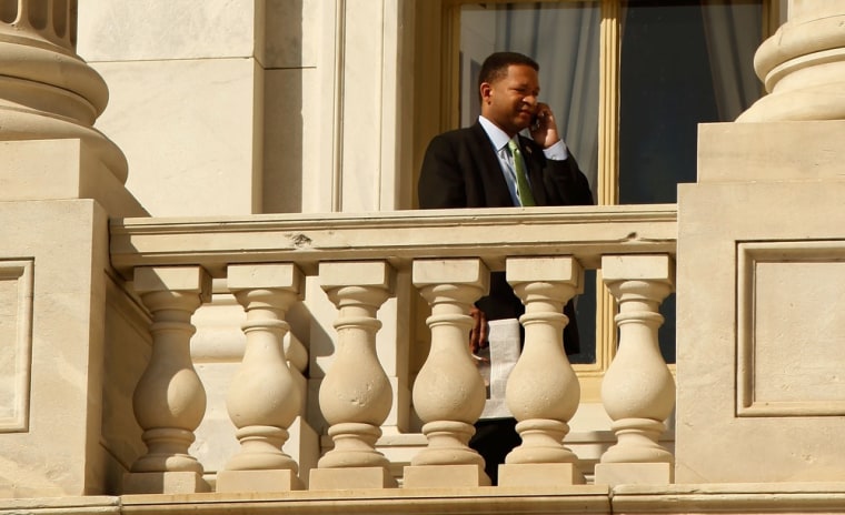 Rep. Artur Davis (D-AL) talks on the phone while standing on a balcony outside the U.S. Capitol March 19, 2010 in Washington, DC.