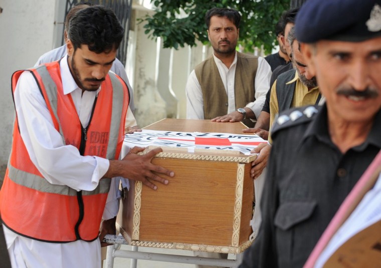 Pakistani volunteers carry the coffin of British aid worker Khalil Dale, before handing it over to Red Cross officials in Quetta on April 30.
