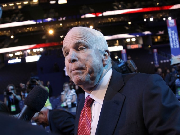 A reporter, left, tries to interview Sen. John McCain, R-Ariz., as he walks the floor of the Republican National Convention, Wednesday, Aug. 29, 2012, in Tampa, Fla.