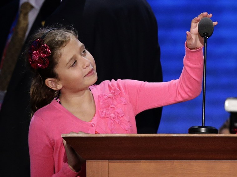 Liza Ryan, daughter of Republican vice presidential nominee, Rep. Paul Ryan of Wisconsin checks out the podium microphone during a tour of the main stage at the Republican National Convention in Tampa, Fla., on Wednesday, Aug. 29.