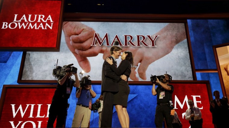 Bradley Thomson, production manager for the Republican National Convention, left, proposes to his girlfriend Laura Bowman, a production coordinator, on the stage at the convention hall in Tampa on Wednesday.