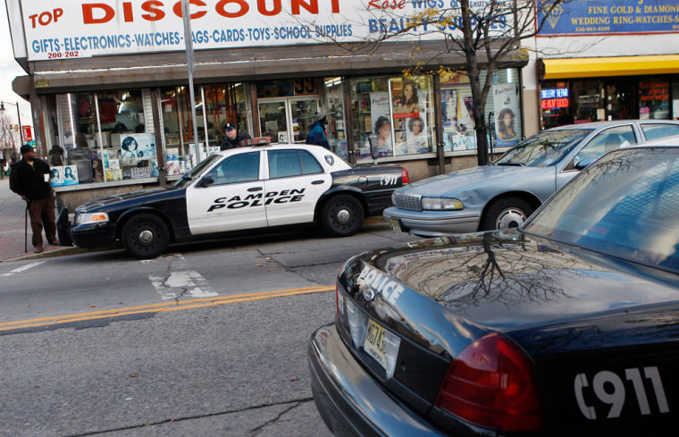 Police are seen in a downtown shopping area in Camden, N.J.