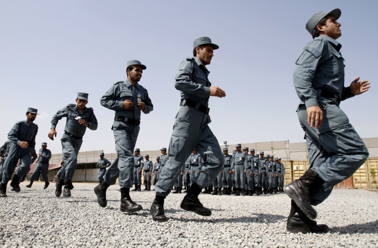 Afghan national police officers run during their graduation ceremony.