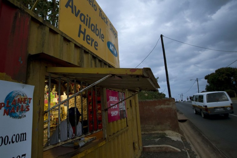 A shopkeeper awaits customers in a shop advertising MTN airtime sales in Umlazi township in Durban, South Africa.