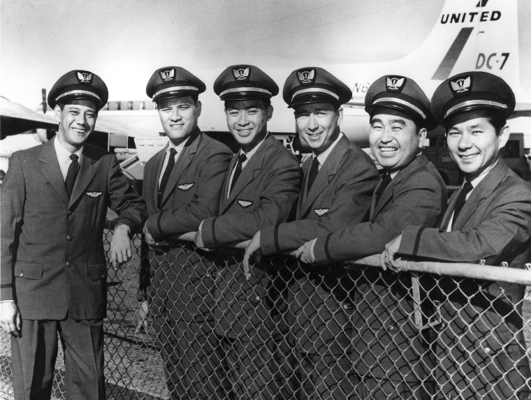 In this 1957 photo provided by his family, Ron Akana, third from right, poses with his United Airlines crewmates in new flight attendant uniforms. Also pictured from left to right is Matt Ah Chong, Clem Keliikipi, Timmy Pang, Eddie Takahashi and Roy Miyose.