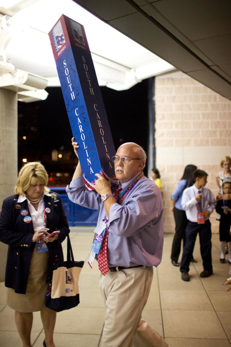 Dr. Mark Hartley of South Carolina carries out a souvenir as he leaves the Tampa Bay Times Forum, site of the RNC. As for Romney's speech,