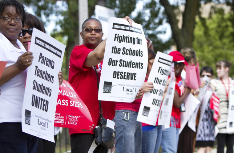 Members of the Chicago Teachers Union hold an informational picket outside Willa Cather Elementary School on Monday in an effort to call attention to ongoing contract talks with the city's Board of Education.