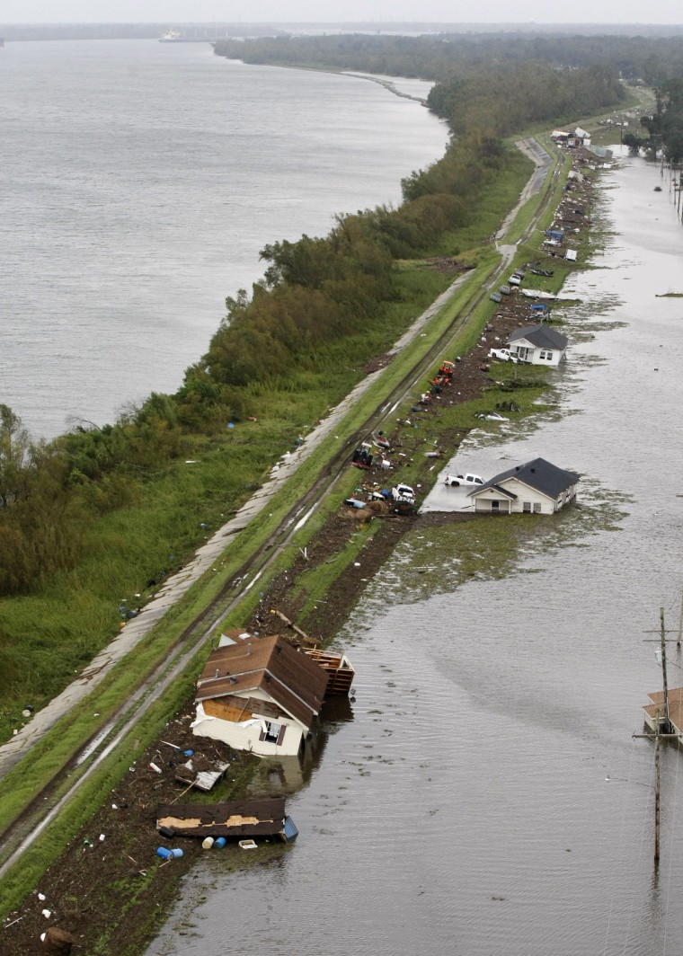 Dislodged homes and debris appear on the levee in the community of Braithwaite, La., along the Mississippi River, at left, after Hurricane Isaac, Aug. 30.