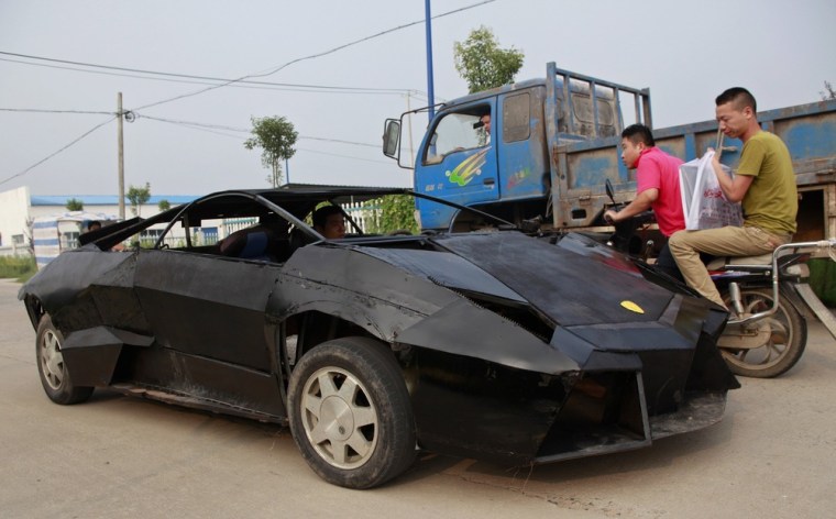 People look at a homemade replica of a Lamborghini Reventon as they drive past it in Suqian, Jiangsu province, China on August 30, 2012.