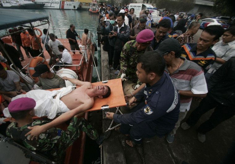 A survivor is carried off an Indonesian rescue boat at Merak seaport on Aug. 31.